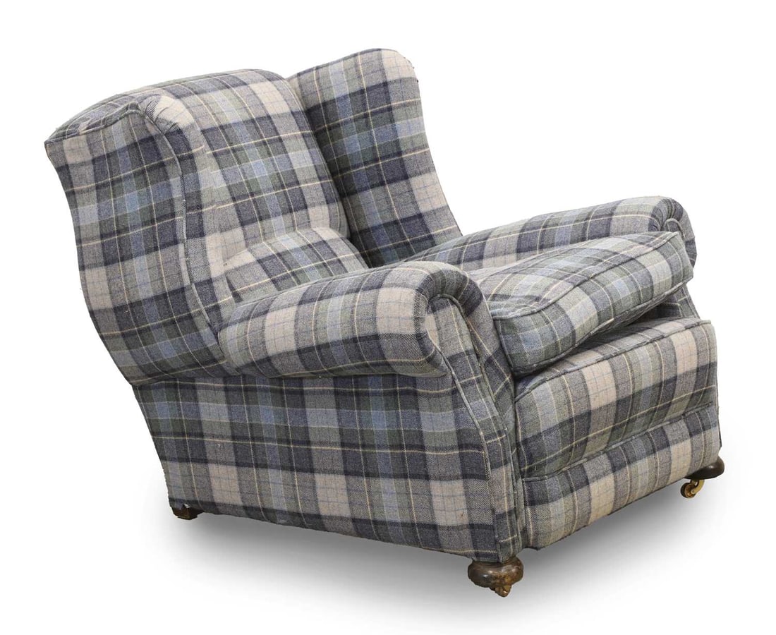 An upholstered club armchair, early 20th century,: An upholstered club armchair, early 20th century, covered in checquered wool fabric 97cm wide, 109cm deep, 92cm high Condition Report: One castor missing and makes the chair unstable