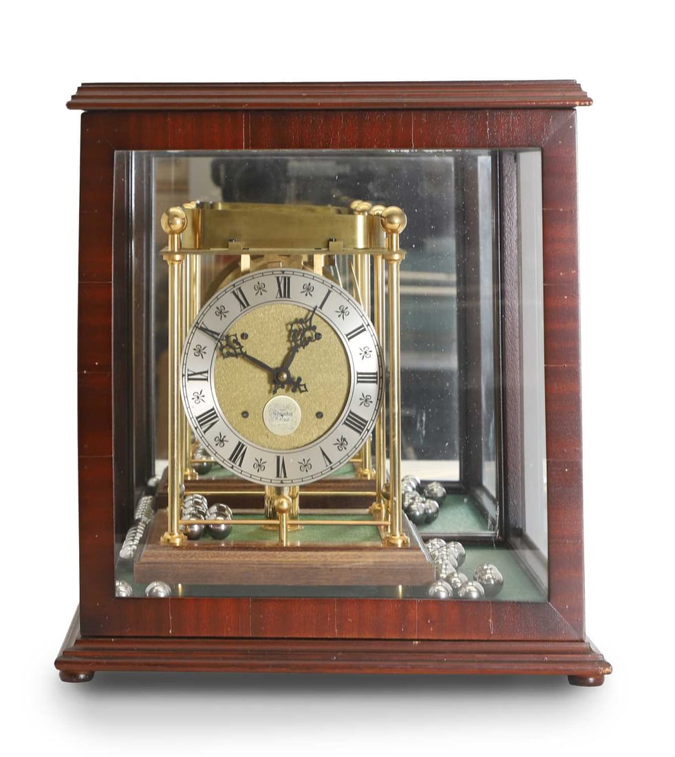 A Thwaites & Reed spheroid weight clock: A Thwaites & Reed spheroid weight clock housed in an oak and glass case, with paperwork, number 962 36cm wide, 36cm deep, 38cm high