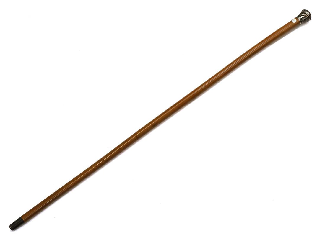 A silver-mounted walking cane, by Thomas Johnson, London, 1892, stamped Brigg,: A silver-mounted walking cane, by Thomas Johnson, London, 1892, stamped Brigg, with a spiral gadrooned pommel, engraved with a monogram and dated 1893, with a Malacca shaft and a horn ferrule 97cm lon