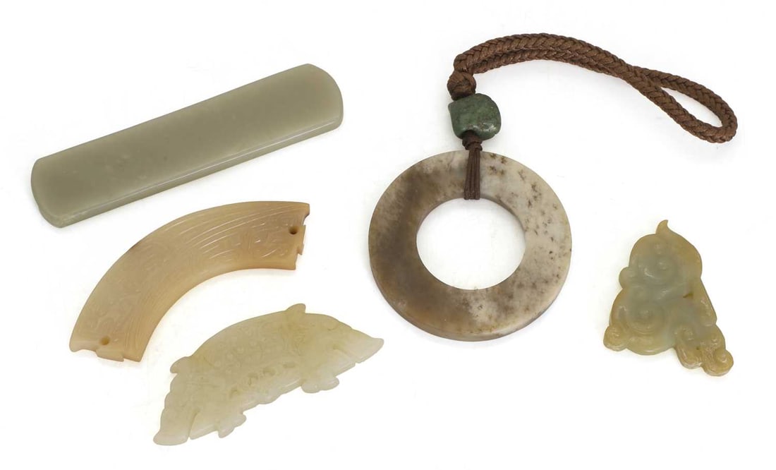 A collection of Chinese jade and hardstone,: A collection of Chinese jade and hardstone, comprising: a circular pendant, a mythical beast, an archaic form pendant, huang, a carved and pierced double-headed dragon pendant and a rectangular fragme