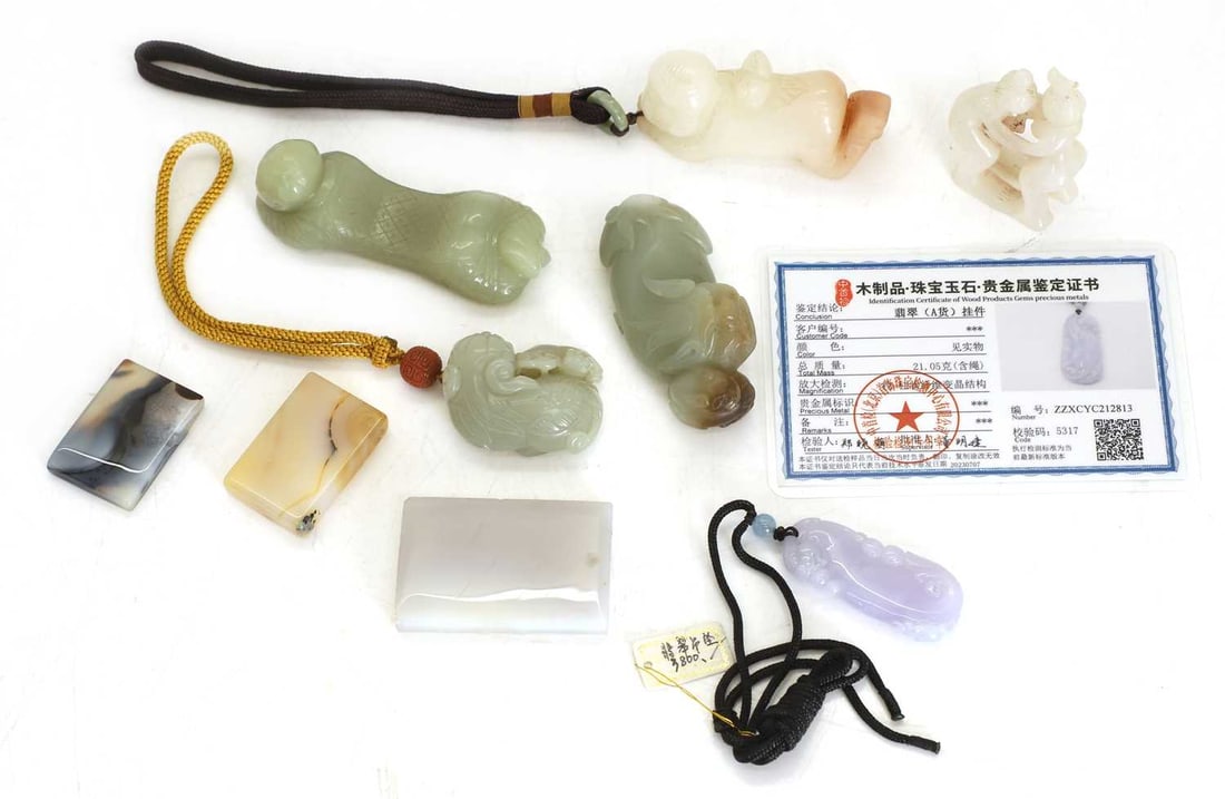 A collection of Chinese jade and hardstone,: A collection of Chinese jade and hardstone, comprising: two reclining boys, a group carving of erotic figures, and two group carvings of recumbent dogs, one example with lingzhi, a jade pendant of a d
