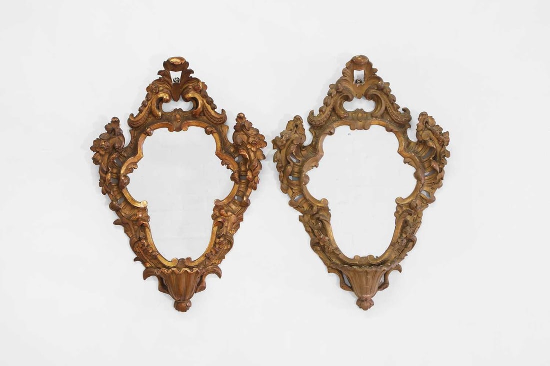 A pair of carved and painted wooden wall mirrors, 20th century, Italian,: A pair of carved and painted wooden wall mirrors, 20th century, Italian, each with a scrolling foliate frame, 41cm wide, 58cm high 2
