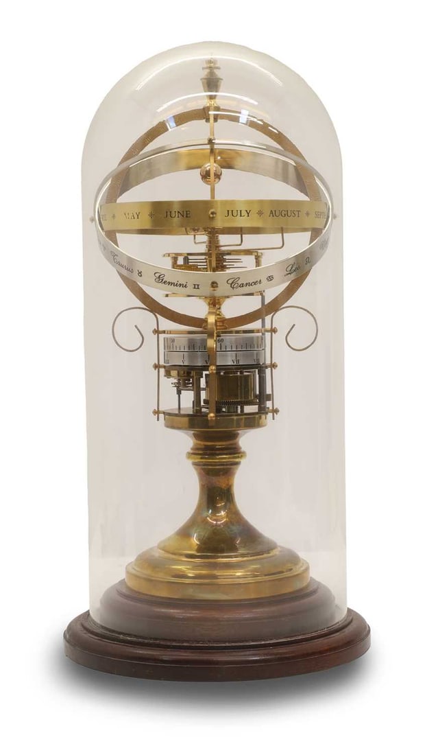 An Orrery Zodiac clock,: An Orrery Zodiac clock, the eight-day movement with outer engraved band, engraved month and zodiac sign set over an open drum, cased in wooden and glazed dome, numbered 925, with paperwork <