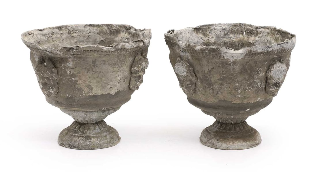A pair of lead urns,: A pair of lead urns, of campana form with masks to the exterior 27cm wide, 22cm high 2 Condition Report: A/f