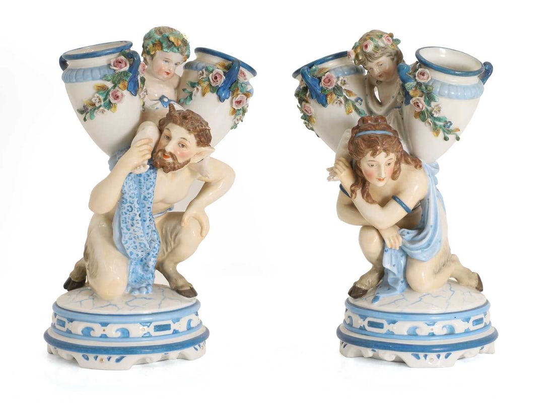 A pair of KPM porcelain vases late 19th / early 20th century: A pair of KPM porcelain vases late 19th / early 20th century modelled as two centaur supporting puttis each holding vases, marked to the base 27.5cm high, 17cm wide, Condition Report: some marks and