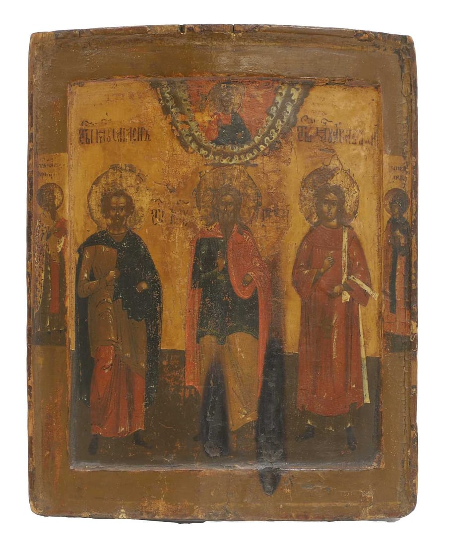 An Eastern Orthodox icon of three saints, late 19th/early 20th century,: An Eastern Orthodox icon of three saints, late 19th/early 20th century, within a raised and decorated border flanked by two figures, tempera on panel 31 x 25cm Condition Report: Significant general