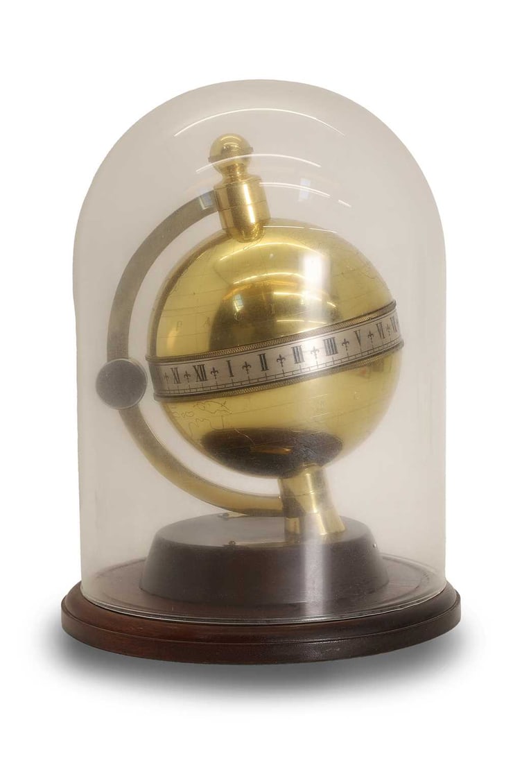 A Charles Frodsham globe clock,: A Charles Frodsham globe clock, by the Heritage Collection, numbered 260/5000, the rotating silvered chapter ring, with a hinged cover enclosing the mechanism, with paperwork 26cm wide, 32cm high