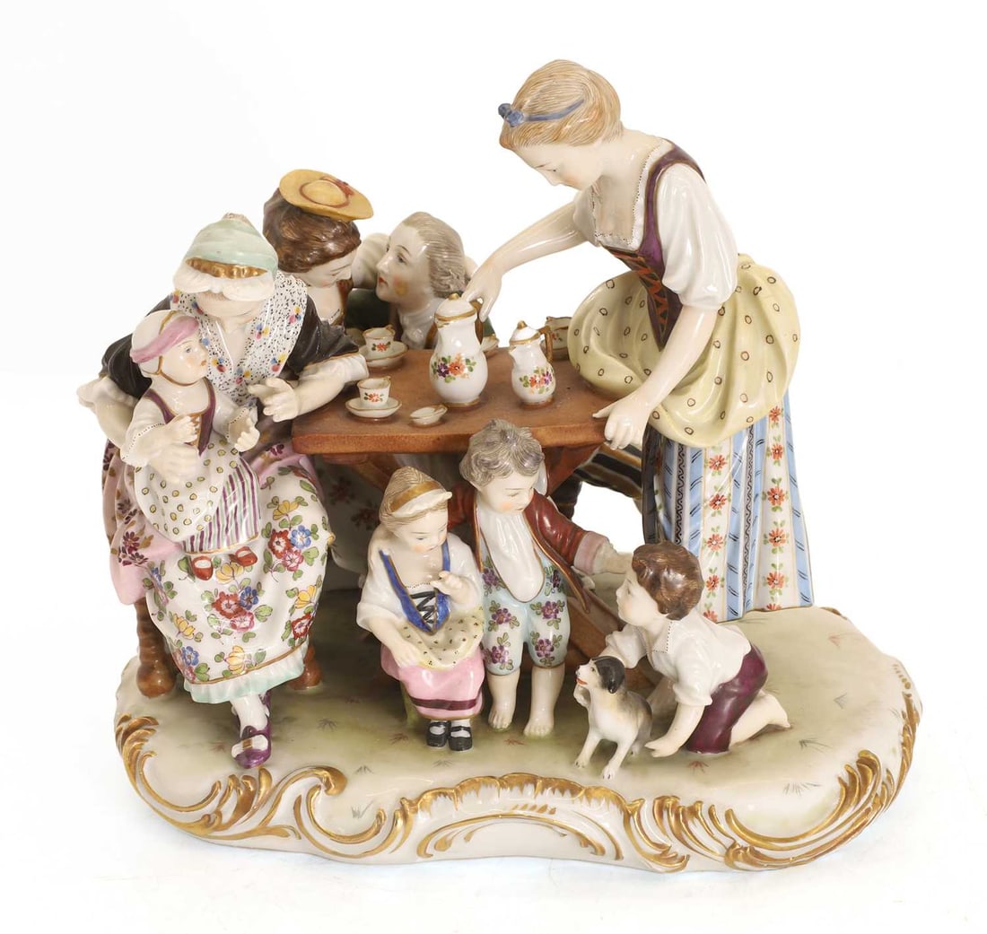 A 'Kaffee Gesellschaft Furstenberg' style figural group, 19th century,: A 'Kaffee Gesellschaft Furstenberg' style figural group, 19th century, depicting a coffee party with eight members and a dog, stamped A.a.M? to the base with a rubbed blue signature 22.5cm wide,17cm