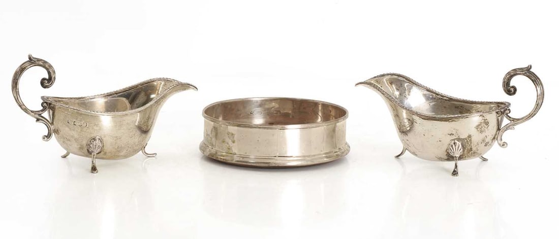 A collection of silver,: A collection of silver, a pair of silver sauce boats, Sheffield, 1918, with beaded rims, and a silver and wooden wine coaster by BB, London with a turned wooden base Sauce boats, 16.5cm wide, total