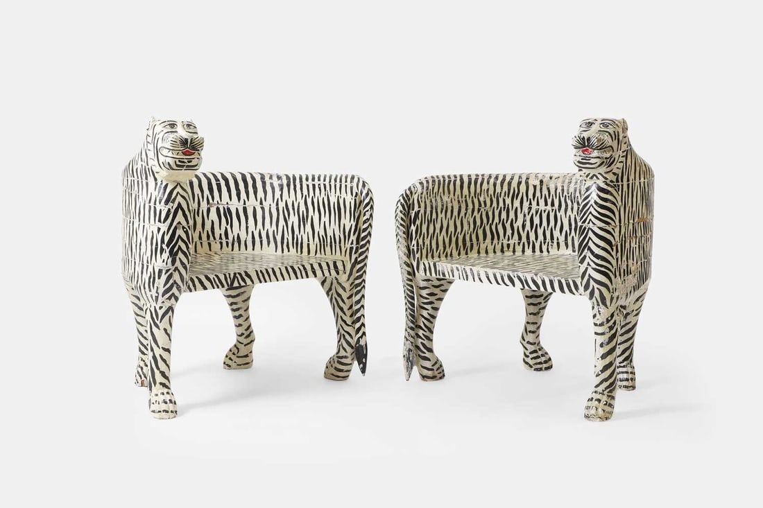 A pair of painted wooden and papier mâché tiger chairs, of recent manufacture, Indian,: A pair of painted wooden and papier mâché tiger chairs, of recent manufacture, Indian, each of curved shape, decorated with black and white detail 82cm wide, 67cm deep, 90cm high 2 Condition
