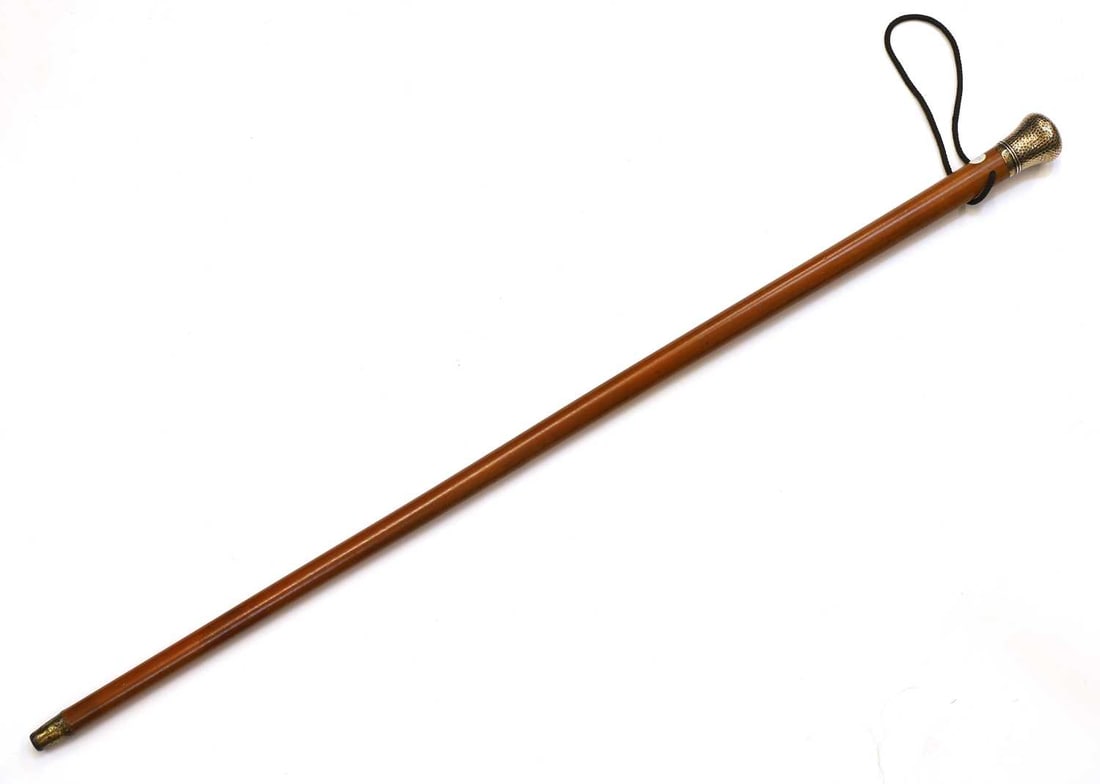 A silver-gilt mounted walking cane, by Thomas Johnson, London, 1900, stamped Brigg,: A silver-gilt mounted walking cane, by Thomas Johnson, London, 1900, stamped Brigg, with a hammered pommel, engraved 'AMG', with a Malacca shaft and a metal and horn-mounted ferrule 84cm long Conditio