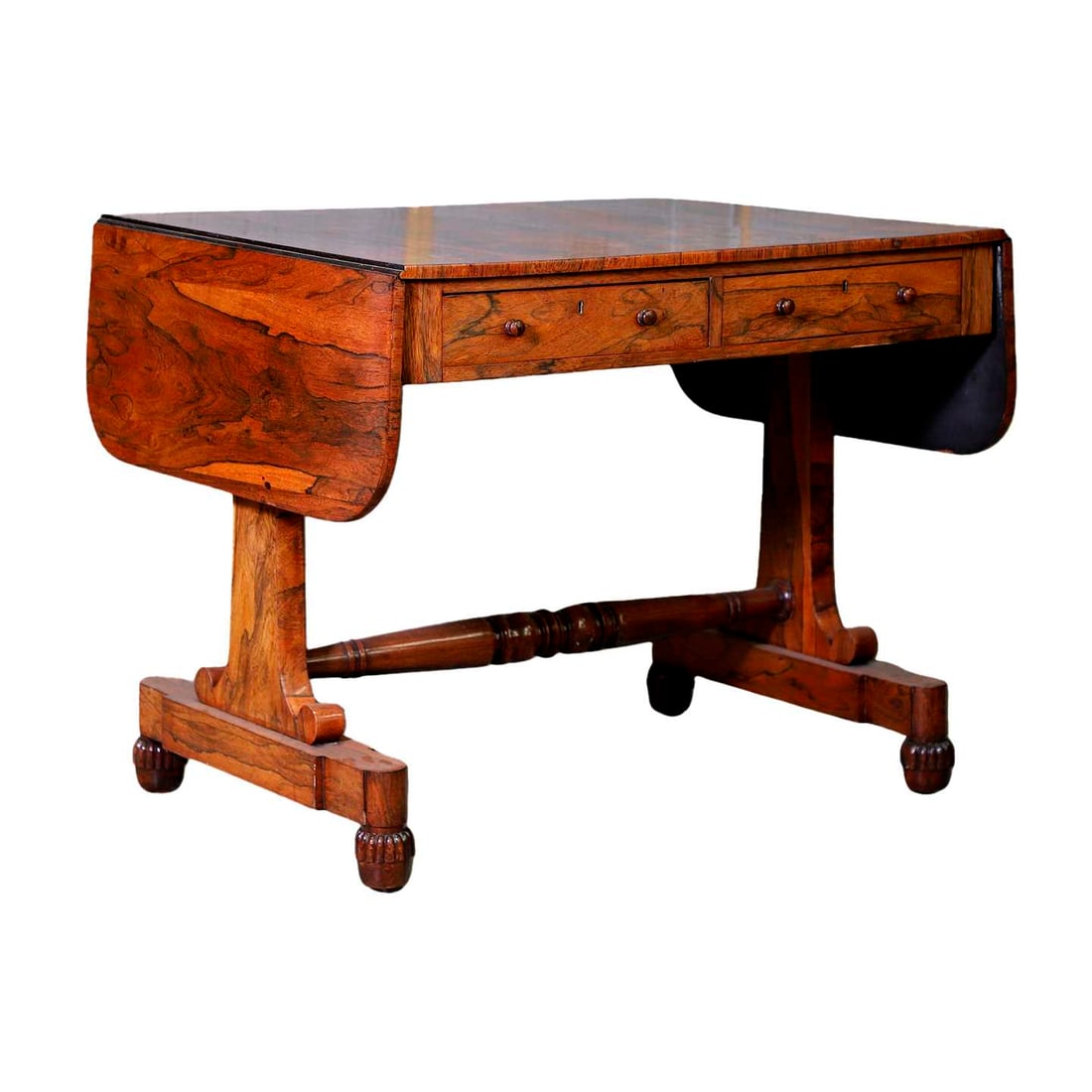 A rosewood sofa table, circa 1840: A rosewood sofa table, circa 1840 with two frieze drawers, on frat supports, united with a turned stretcher, on gadrooned ball feet, with castors 88cm wide, 142cm open, 68cm deep70.5cm high Condition 