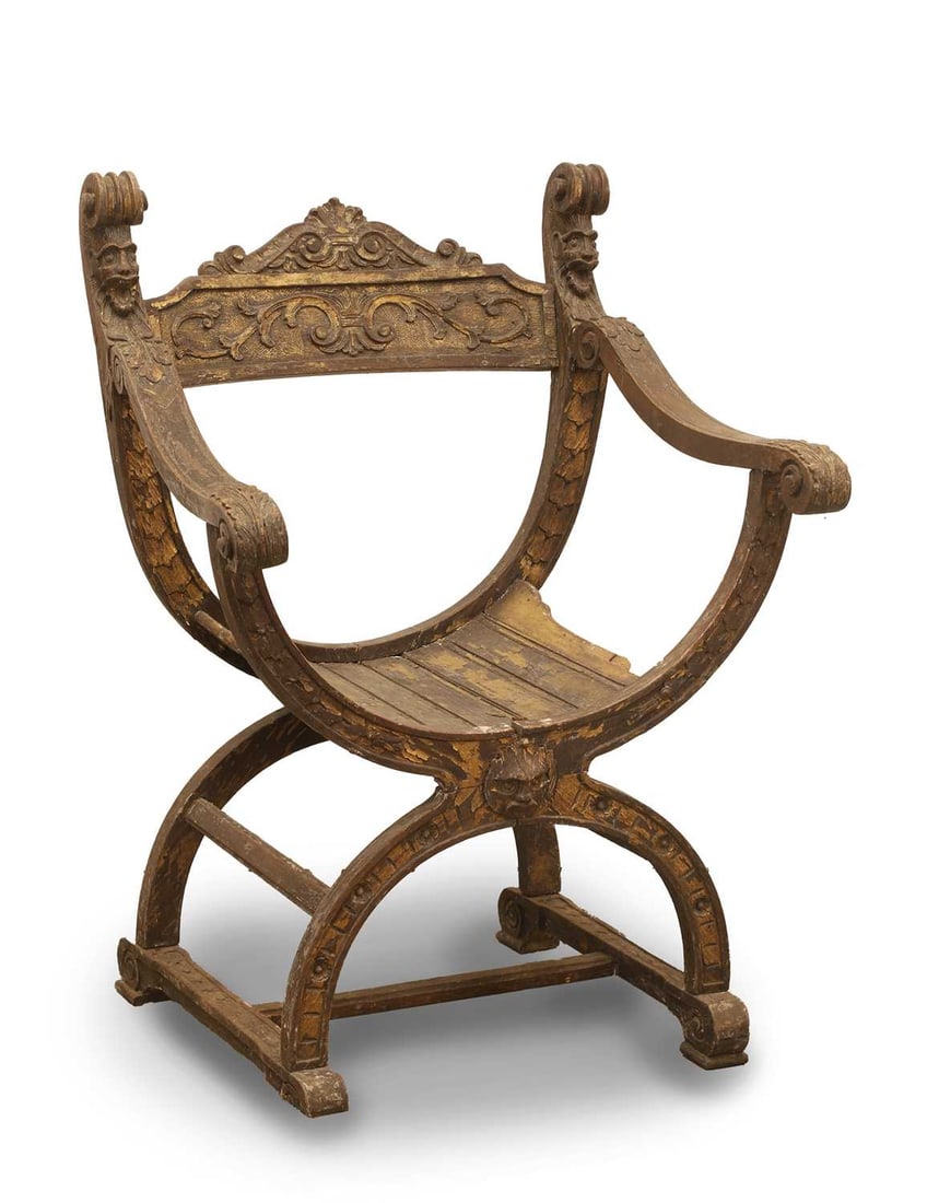An Italian walnut and parcel gilt X-frame chair, 19th century,: An Italian walnut and parcel gilt X-frame chair, 19th century, the top rail with mask supports, and scrolled decoration to the back splat 61cm wide, 58cm deep, 84cm high Condition Report: Loss ot the