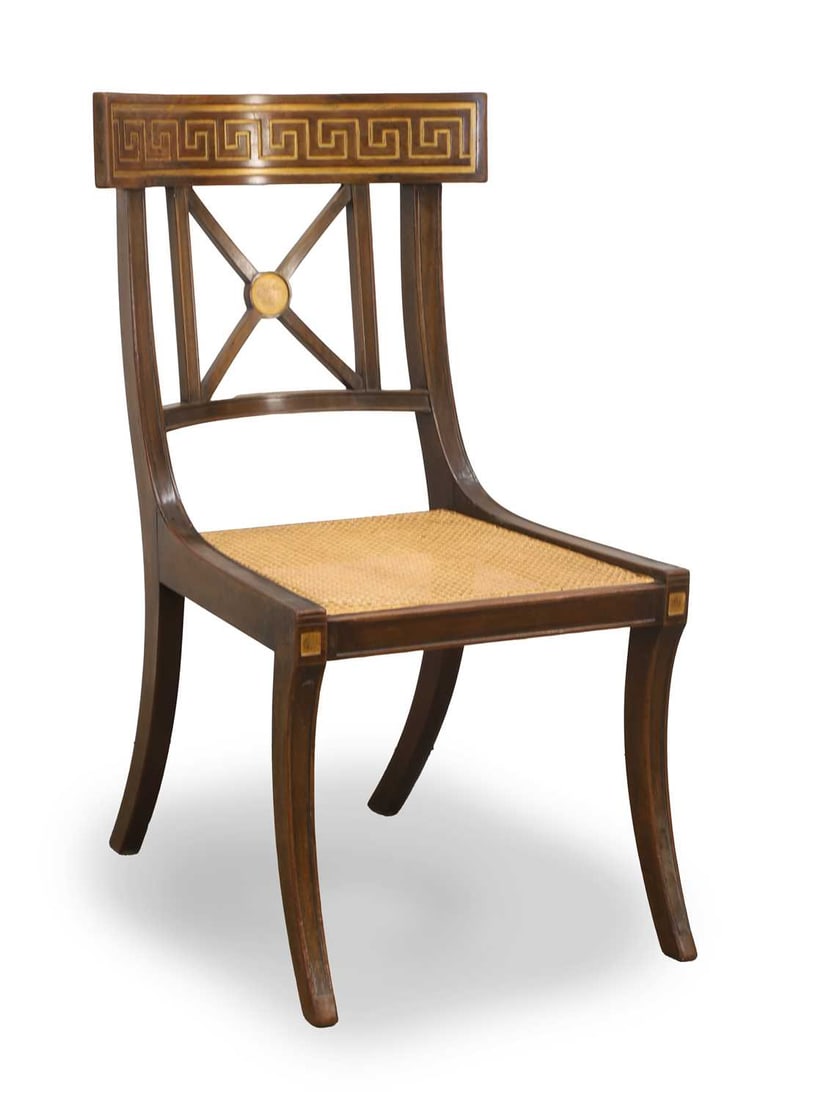 A Regency style klismos chair, late 19th/ early 20th century,: A Regency style klismos chair, late 19th/ early 20th century, retailed by Henry, 1 New Burlington Street, London, with an ivorine plaque to the base, the caned seat below a key pattern bar back