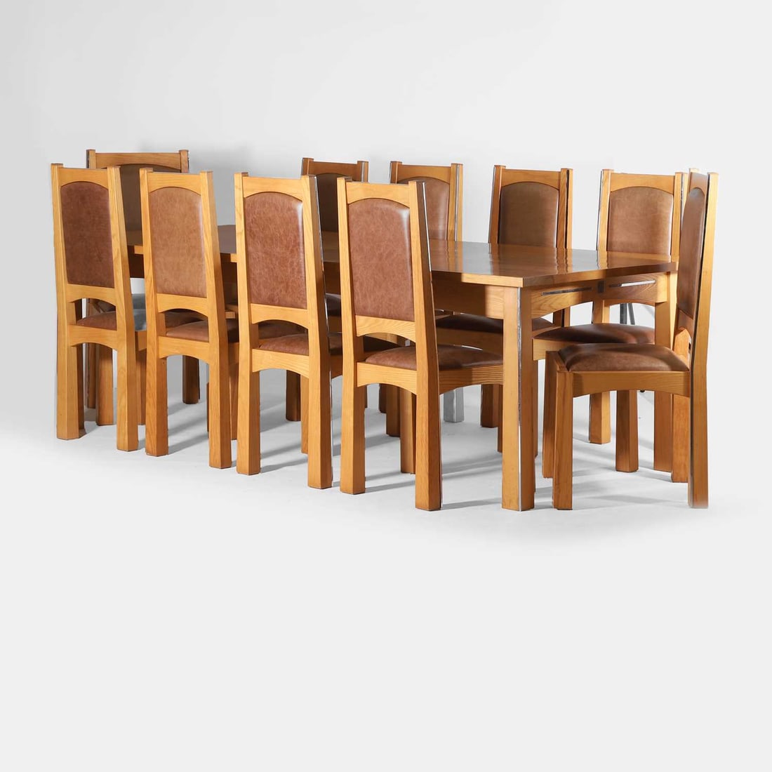 Neil Rymer (b.1964): Neil Rymer (b.1964) a dining suite, c.2002, ash and nickel plate, the chairs upholstered with brown leather seat pads, comprising: a dining table, 240cm wide 111cm deep 76cm high, eight dining