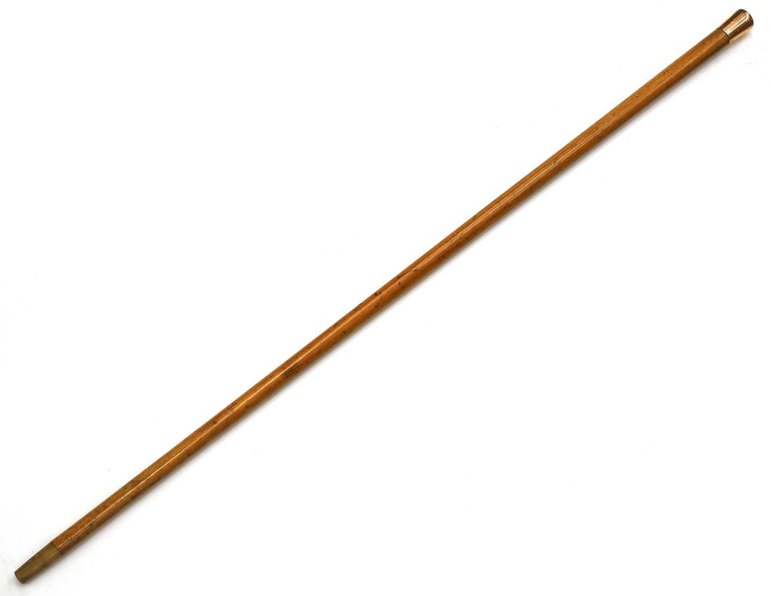 A 12.5ct gold-mounted walking cane, London, 1919, stamped Brigg London,: A 12.5ct gold-mounted walking cane, London, 1919, stamped Brigg London, the pommel handle, engraved with initials 'LP', with a Malacca shaft and a horn ferrule 93.5cm long Condition Report: Shaft