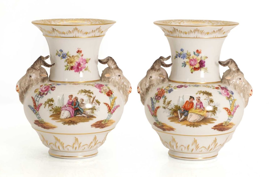 A pair of KPM porcelain ram's head vases 19th century,: A pair of KPM porcelain ram's head vases 19th century, after a design by Friedrich Elias Meyer, with two opposing ram's head handles encasing floral reserves with courting couple scenes to the centre
