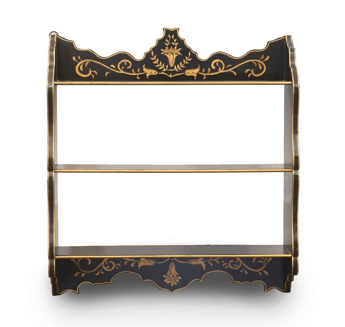 A Regency style black and gilt walll shelf, of recent manufacture,: A Regency style black and gilt walll shelf, of recent manufacture, with gilded floral decoration, and three shelves 66cm wide, 17cm deep, 73cm high Condition Report: Some chipping to the paint. Minor