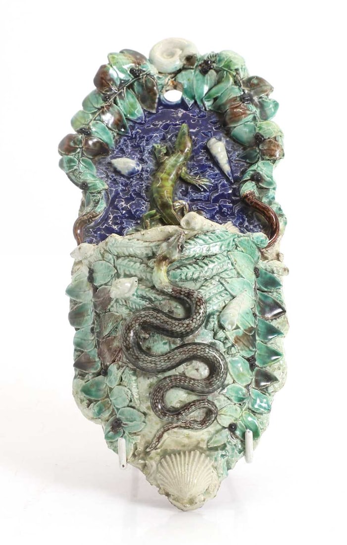 A Palissy style wall pocket and a framed plaster plaque, 20th century,: A Palissy style wall pocket and a framed plaster plaque, 20th century, the wall pocket with a small serpent to the main body and a lizard to the top section, and the plaque depicting a bust of a lady 