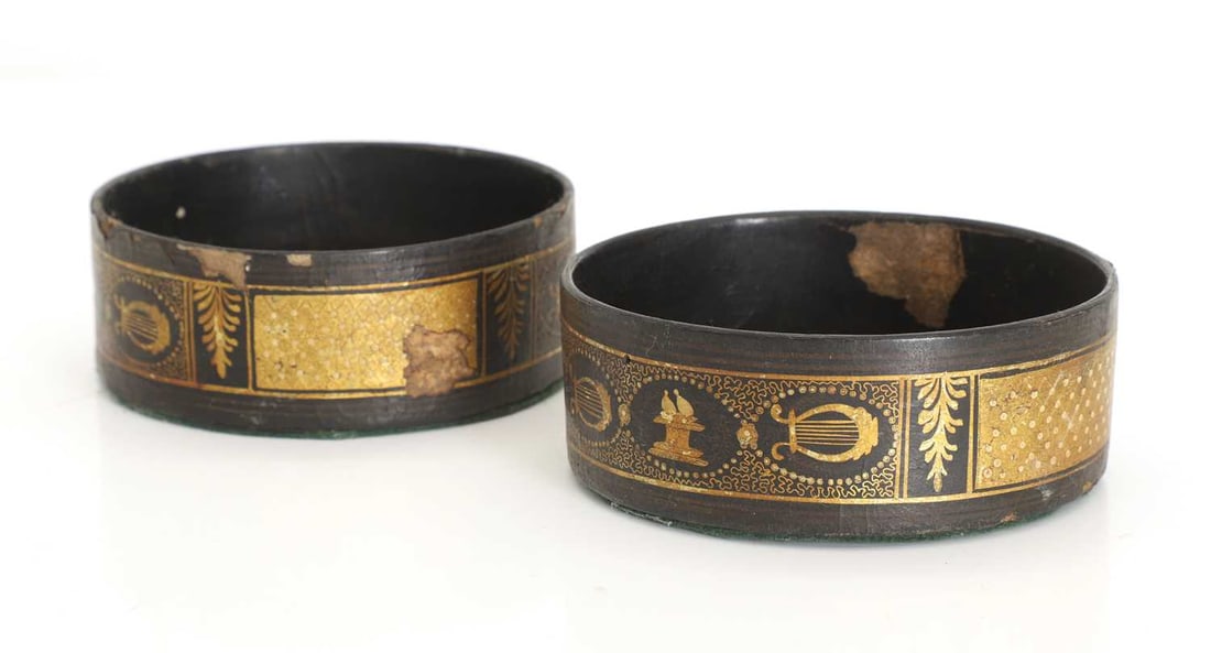 A pair of black japanned bottle coasters, - 2