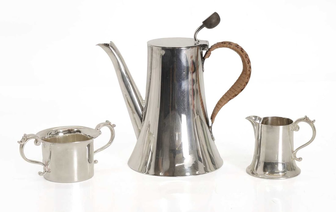 A three piece silver bachelors coffee service: A three piece silver bachelors coffee service by Lee & Wigfull, Sheffield,1906 comprising a coffee pot, milk jug, and sugar bowl 14.5cm high