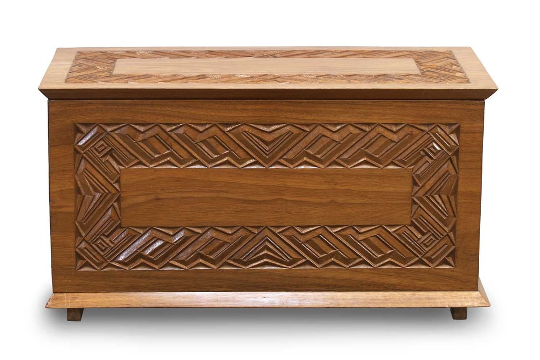 A Conglese carved hardwood chest, mid 20th century,: A Conglese carved hardwood chest, mid 20th century, with cubist cut panels, the tilt top opening to an empty interior 78cm wide, 37.5cm deep, 42cm high
