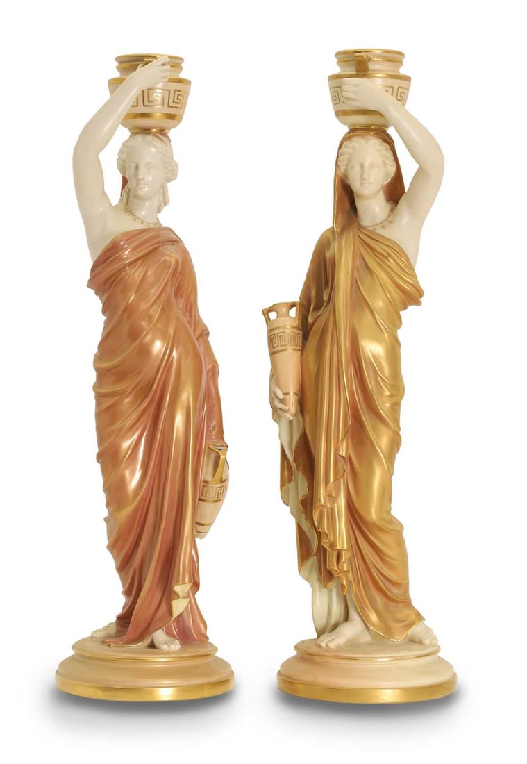 A pair of Royal Worcester figurines, early 20th century,: A pair of Royal Worcester figurines, early 20th century, modelled as water carriers 14cm wide, 52cm high 2 Provenance: The collection of Simon Timothy Blake, Hertfordshire. Condition Report: One chip