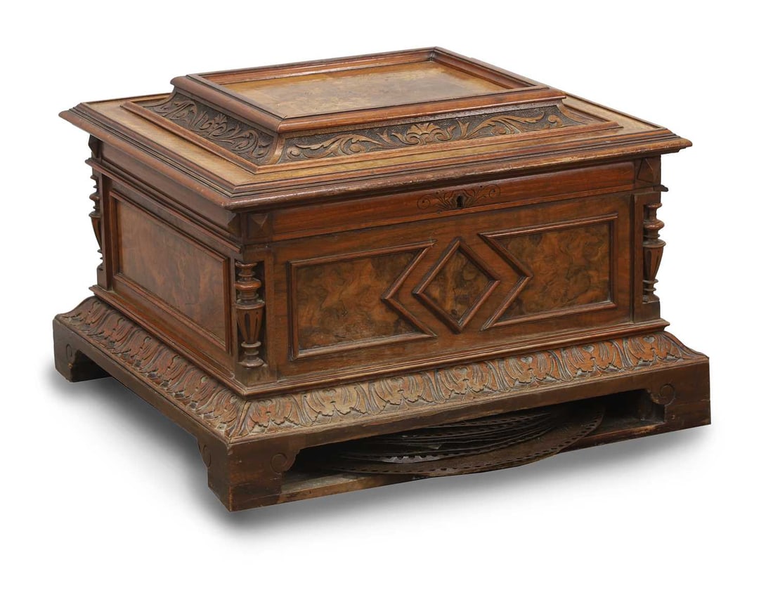 A German walnut cased disc musical box, late 19th century: A German walnut cased disc musical box, late 19th century by polyphon, the foliate inlaid case with foliate carved borders, the hinged lid enclosing twin combs playing a 39.5cm diameter disc,