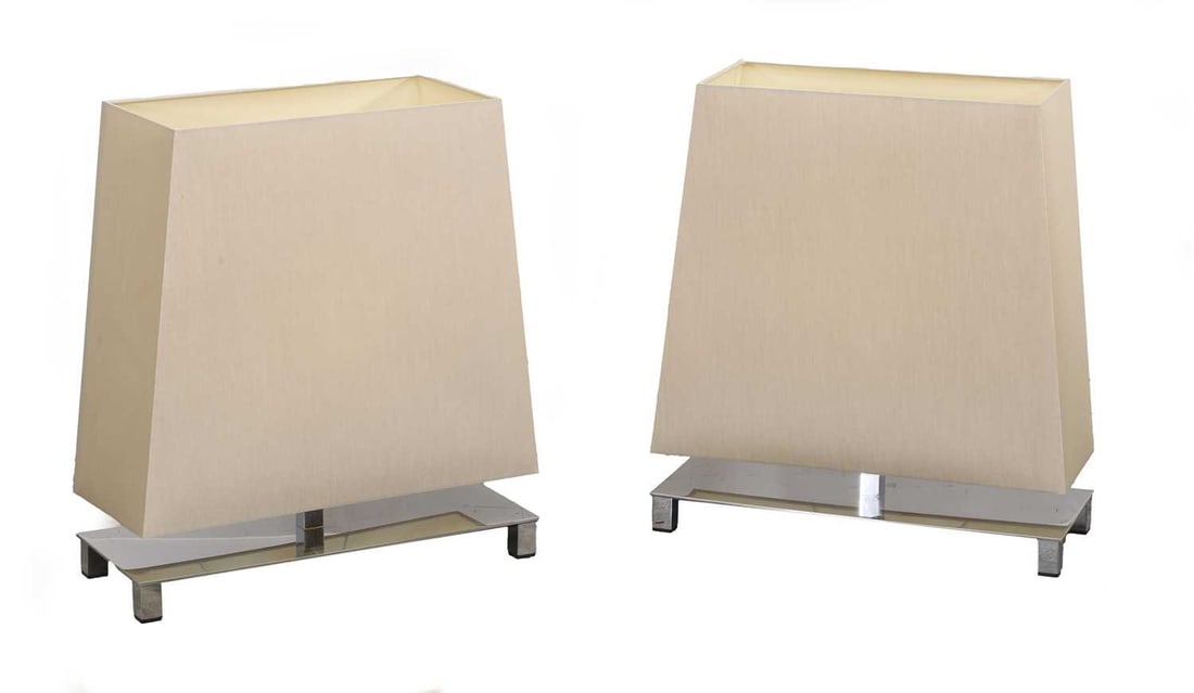 A pair of Contardi table lamps, of modern manufacture,: A pair of Contardi table lamps, of modern manufacture, chrome with cream fabric shades, and labelled to the base 50cm wide, 55.2cm high 2