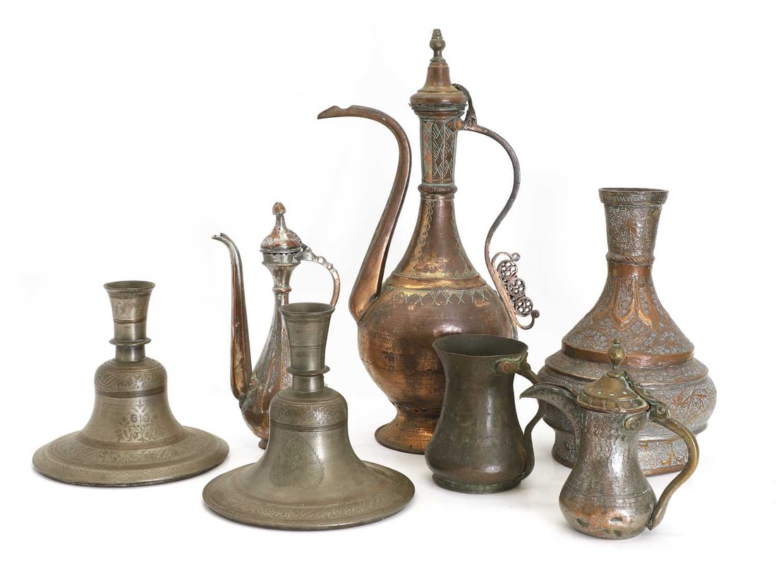 A collection of Indian copper and brass metalwares, 19th-20th century,: A collection of Indian copper and brass metalwares, 19th-20th century, comprising a pair of hookah bases, each with engraved foliate decoration, a Kashmiri copper vase decorated with palmettes and