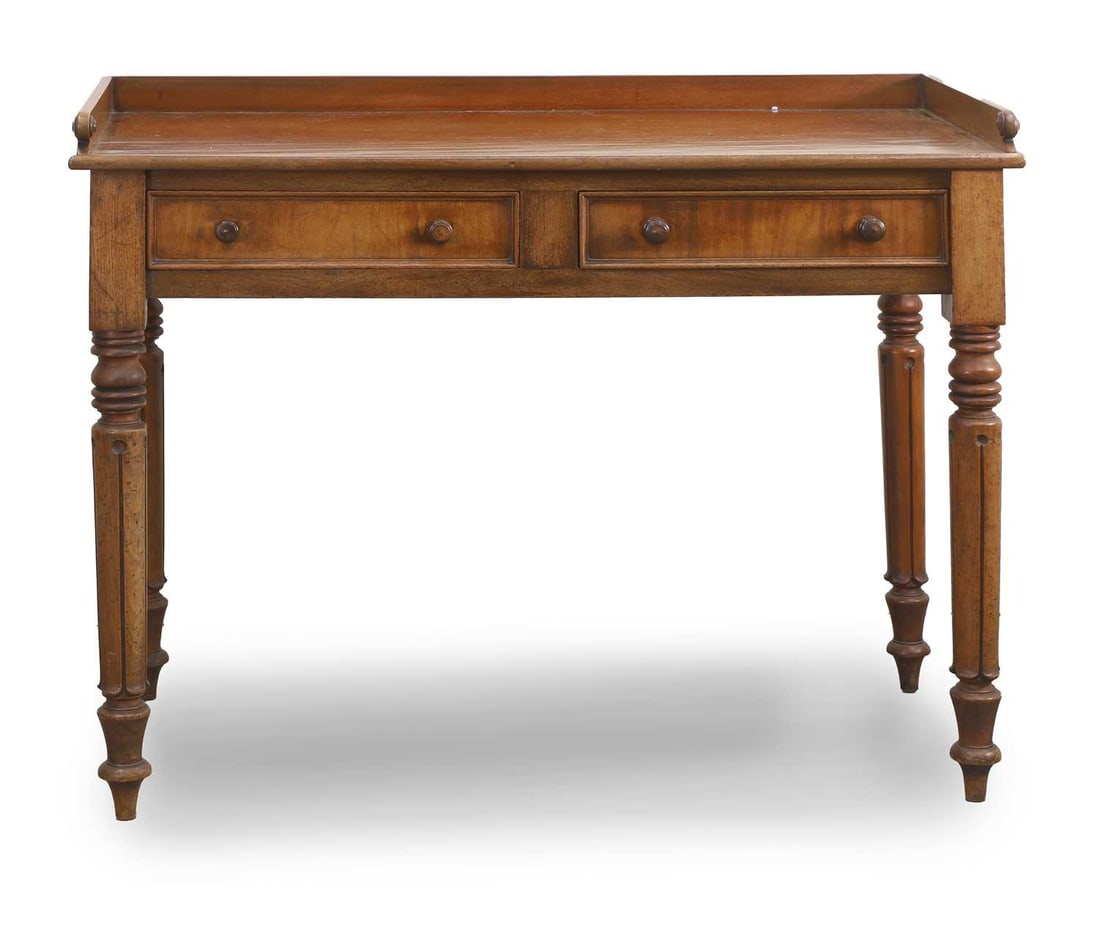A William IV mahogany writing table, circa 1830,: A William IV mahogany writing table, circa 1830, fitted with two frieze drawers, each with twin pulls, over turned and carved legs 105cm wide, 50cm deep, 81.5cm high to back