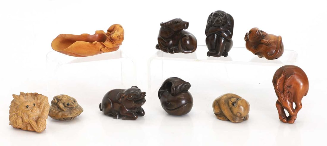 A collection of Japanese wood netsuke, 20th century,: A collection of Japanese wood netsuke, 20th century, carved as various animals, mythical beasts and reptiles, comprising a gazelle, monkeys, mice, a whale, a buffalo, a frog, a dragon and a pig the