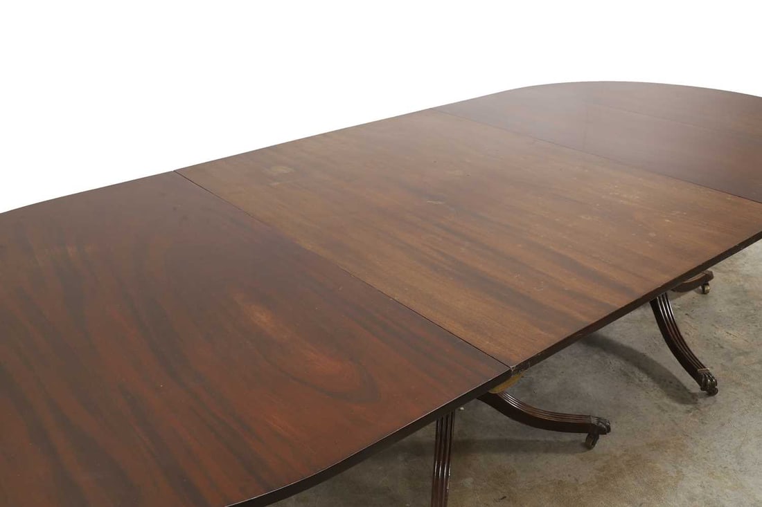 A mahogany triple pillar dining table, 19th century, - 2
