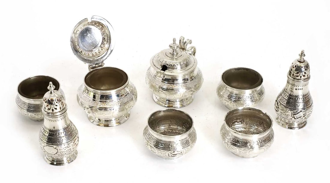 A set of silver salts, pepperettes, and mustards, Victorian,: A set of silver salts, pepperettes, and mustards, Victorian, by Goldsmiths' Alliance Ltd, London, 1887, including some liners, decorated with floral banding Pepperette, 9.7cm high, total 17.8ozt