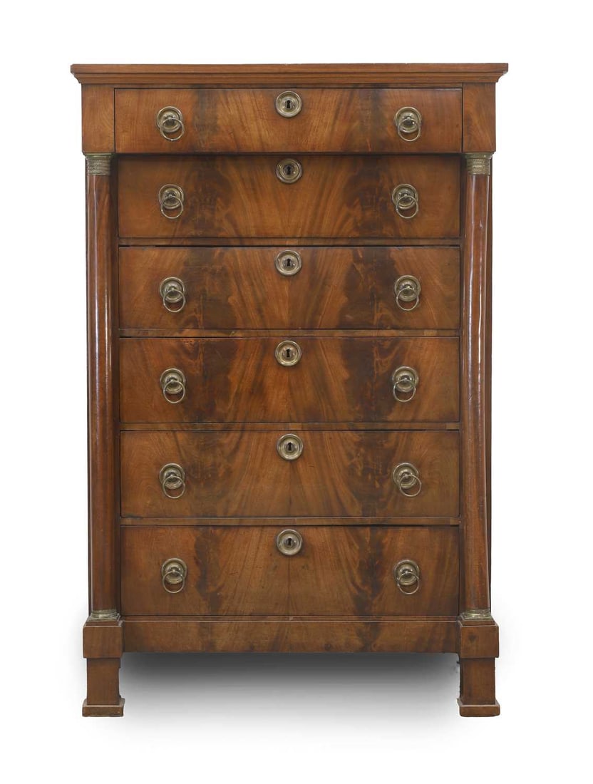 An Empire mahogany six drawer chest, 19th century,: An Empire mahogany six drawer chest, 19th century, mounted with brass ring handles and escutcheons, flanked with turned columns 103cm wide, 52cm deep, 155cm high