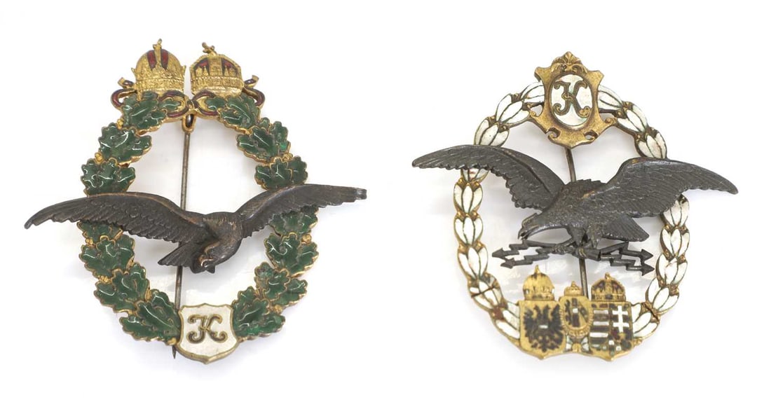 An Austro-Hungarian WWI 1917 aircrew badge and an Austrian pilot's badge, type II: An Austro-Hungarian WWI 1917 aircrew badge and an Austrian pilot's badge, type II both with laurel wreaths in white and green enamel 5.8 x 6cm 2 Condition Report: Both worn and enamel losses. The A-H