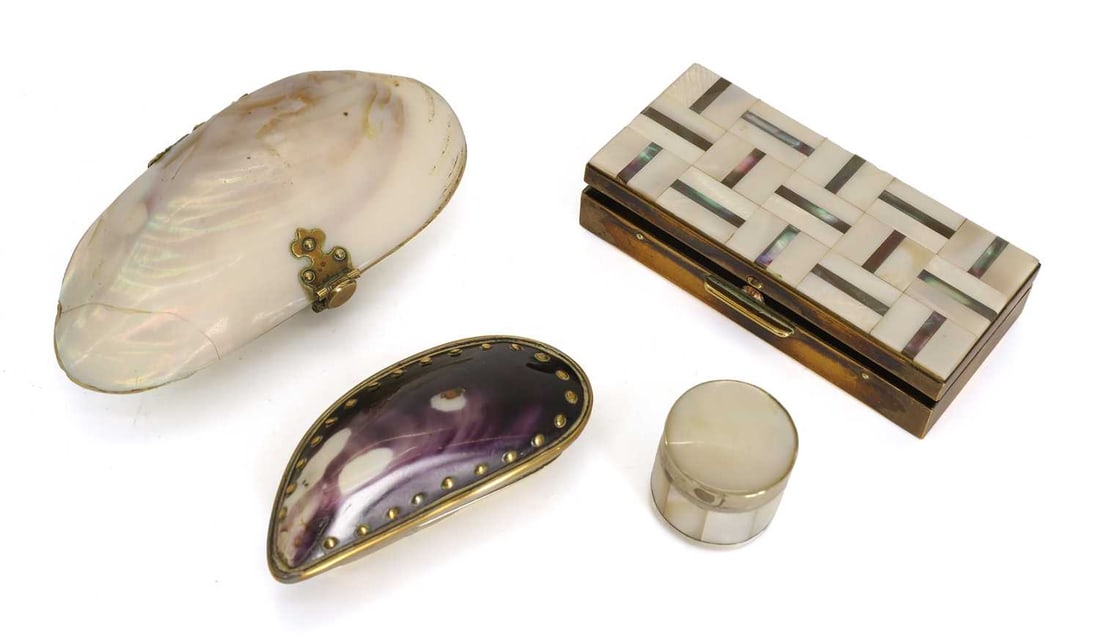 A group of brass mounted shell items,: A group of brass mounted shell items, comprising a mussel shell snuff box, a mother of pearl pill box with metal mounts, a mother of pearl box, and a shell mounted purse Mother of pearl box, 9cm wide 