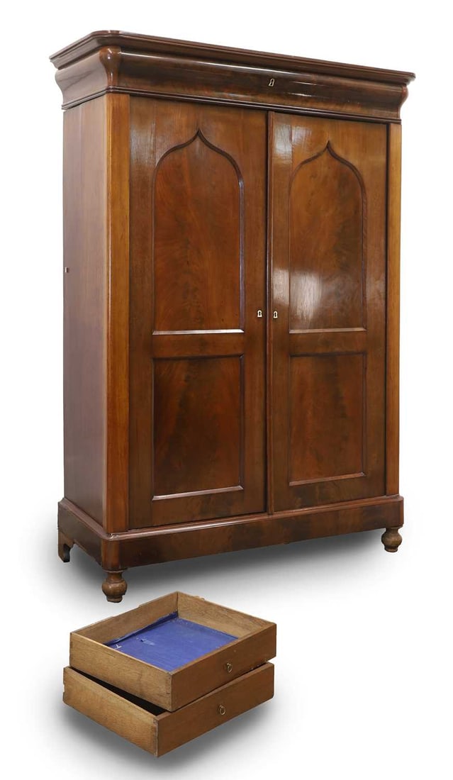 A mahogany drinks cabinet, 19th century,: A mahogany drinks cabinet, 19th century, with a cushion top drawer, over arabesque arched cupboards, with ivory escutcheons and a single key, enclosing interior shelves, raised on bun feet 115cm wide,