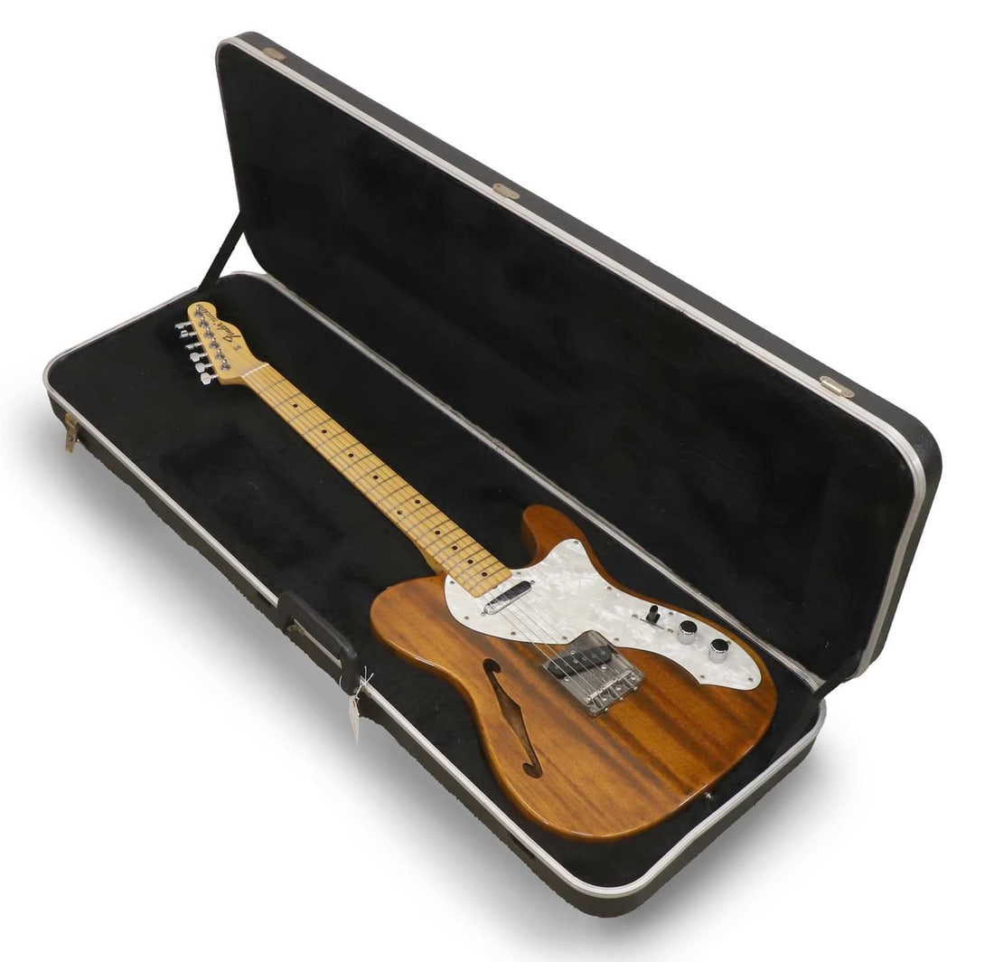 A Fender Telecaster Thinline, circa 1993,: A Fender Telecaster Thinline, circa 1993, made in Japan, serial. A062697, model. 0277702521, the mahogany body with pearl pick guard, two knobs and a three way switch, presented within a rectangular f