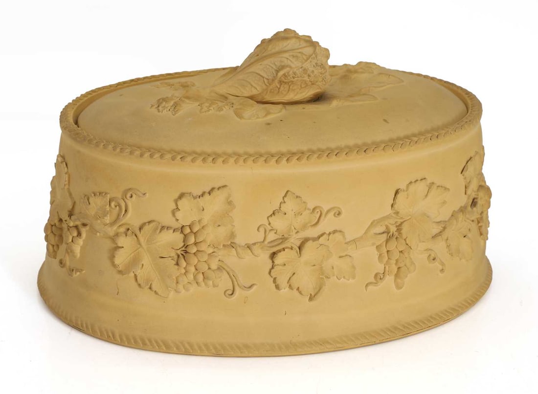 A Wedgwood caneware game pie dish, cover and liner, mid 19th century,: A Wedgwood caneware game pie dish, cover and liner, mid 19th century, of oval form and moulded with fruiting vines and a cabbage knop, impressed marks 29cm wide 3 Condition Report: Inner sleeve