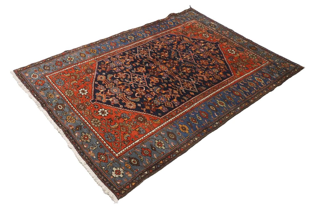 A Persian rug, 20th century,: A Persian rug, 20th century, the dark blue ground with blue border surrounding a red central field decortaed with floral and stylised bird motifs, 137x202