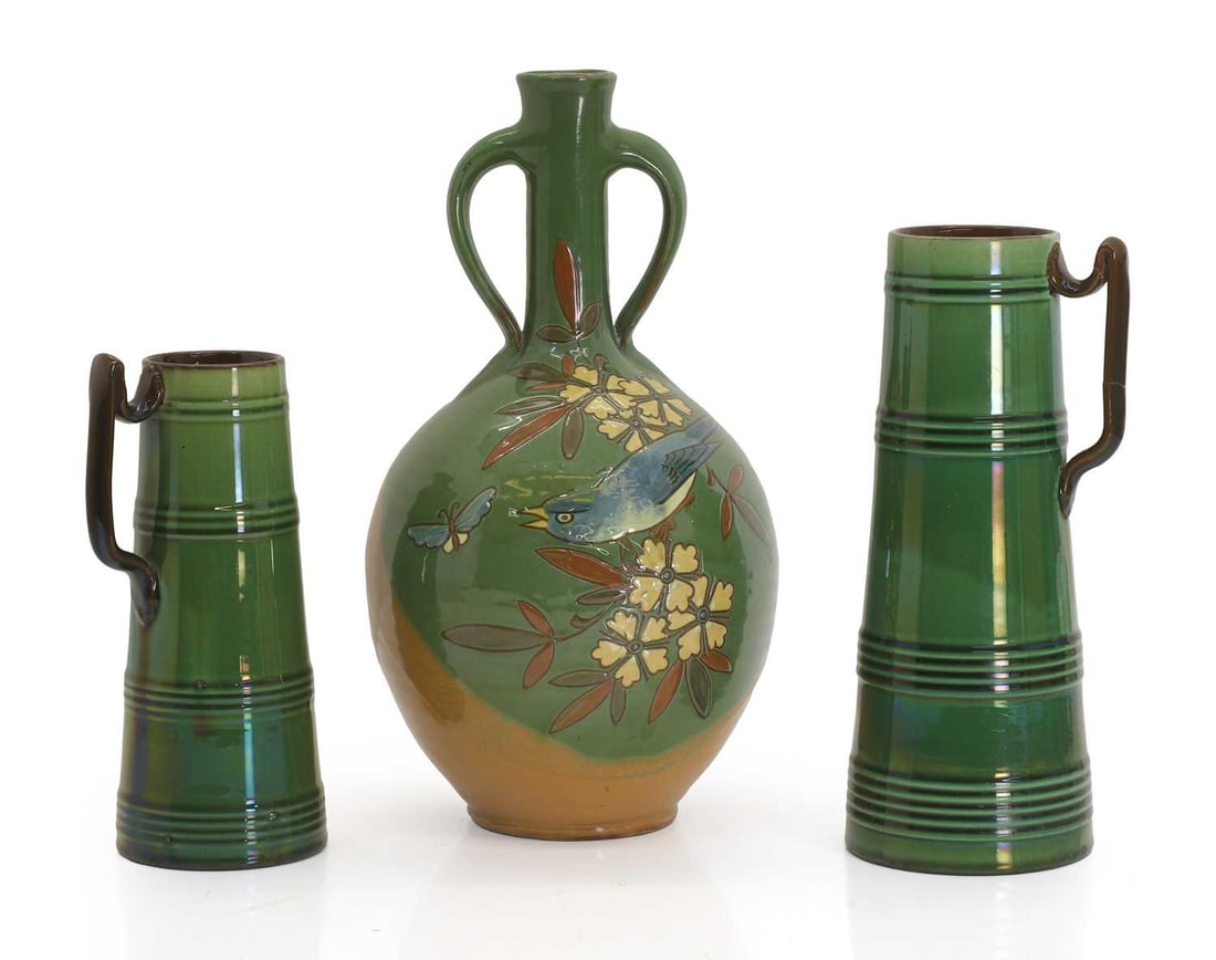 A C H Brannam Pottery vase, by William Baron,: A C H Brannam Pottery vase, by William Baron, the twin handled vase with green glaze and fish detail, together with a graduated pair of green glazed pottery vases, with ribbed design and incised