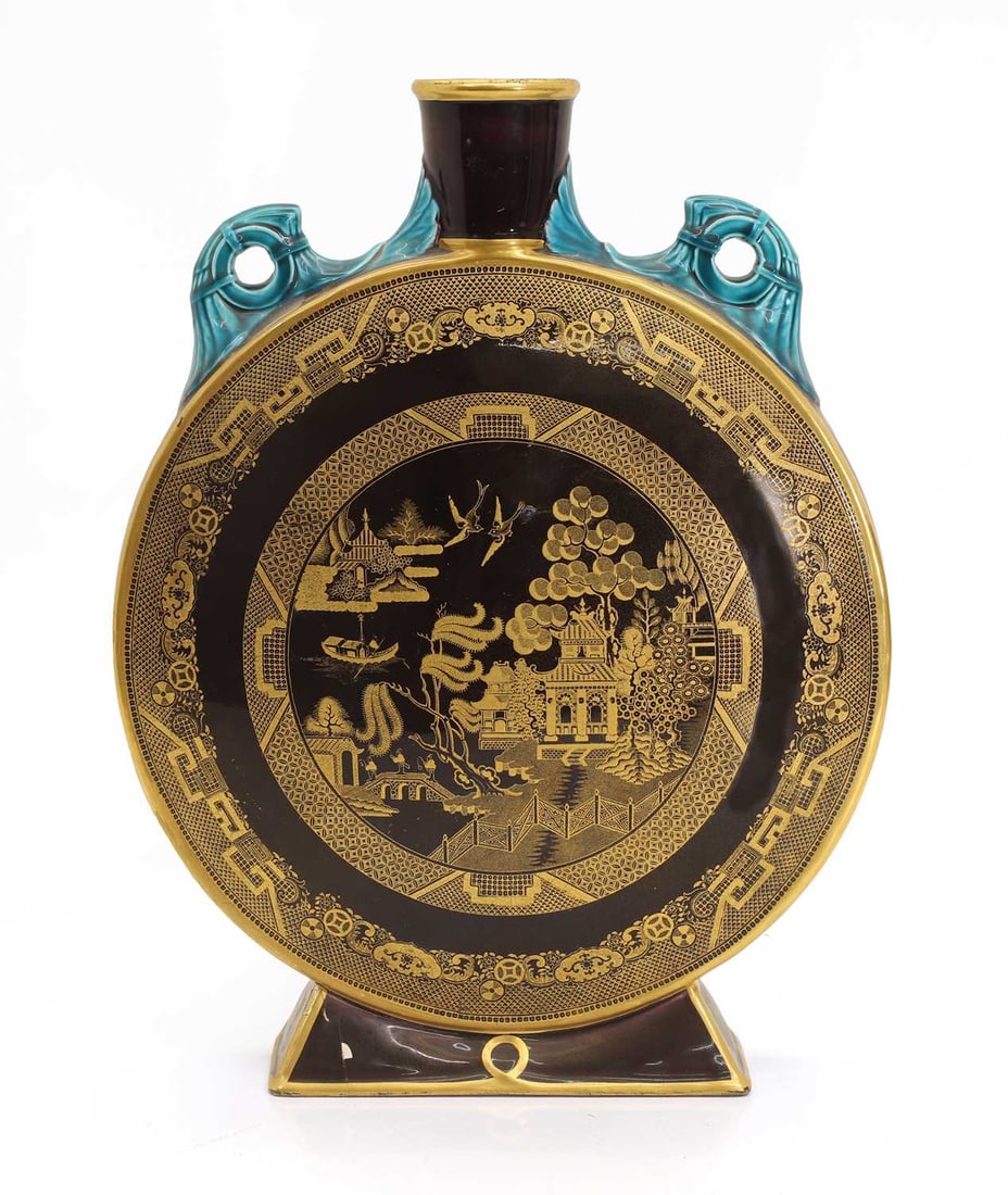 A Minton aesthetic movement pottery moon flask, late 19th century,: A Minton aesthetic movement pottery moon flask, late 19th century, with a pair of ring handles and an angular foot, the body with a chinoiserie scene, impressed marks to the underside 28cm wide, 36cm
