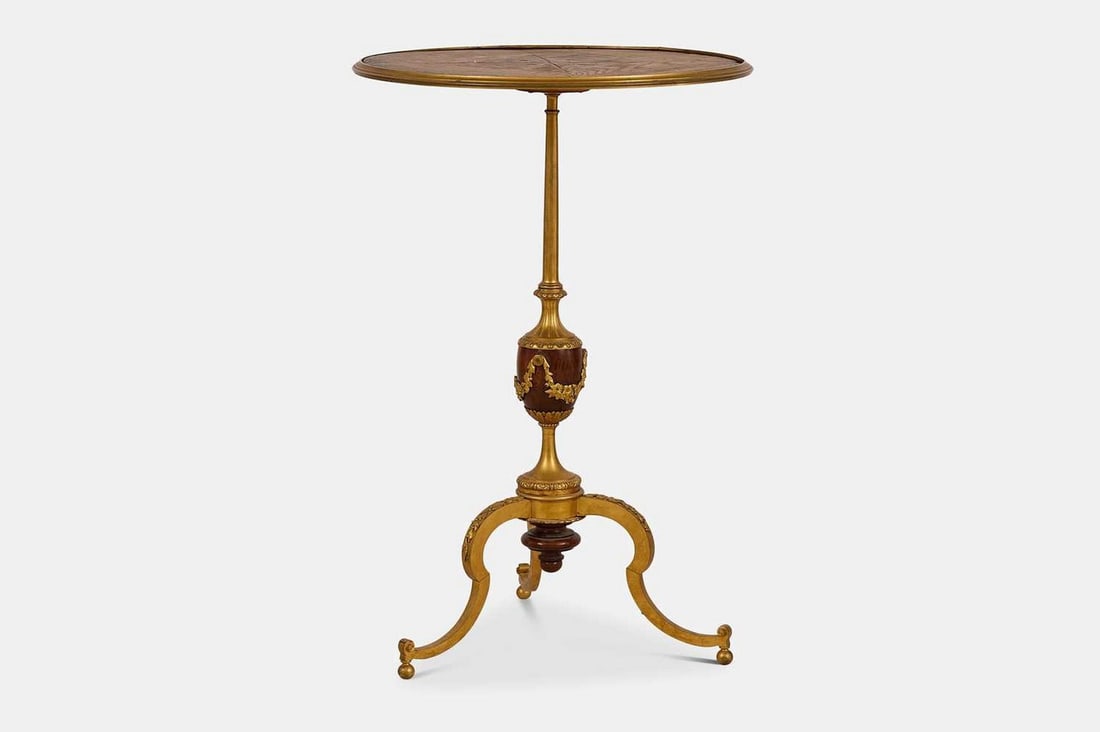An ormolu occasional table by Tahan, Paris, first quarter of the 19th century, French,: An ormolu occasional table by Tahan, Paris, first quarter of the 19th century, French, the circular top raised on a baluster column set with an urn, terminating in a scrolling tripod base, engraved 'T