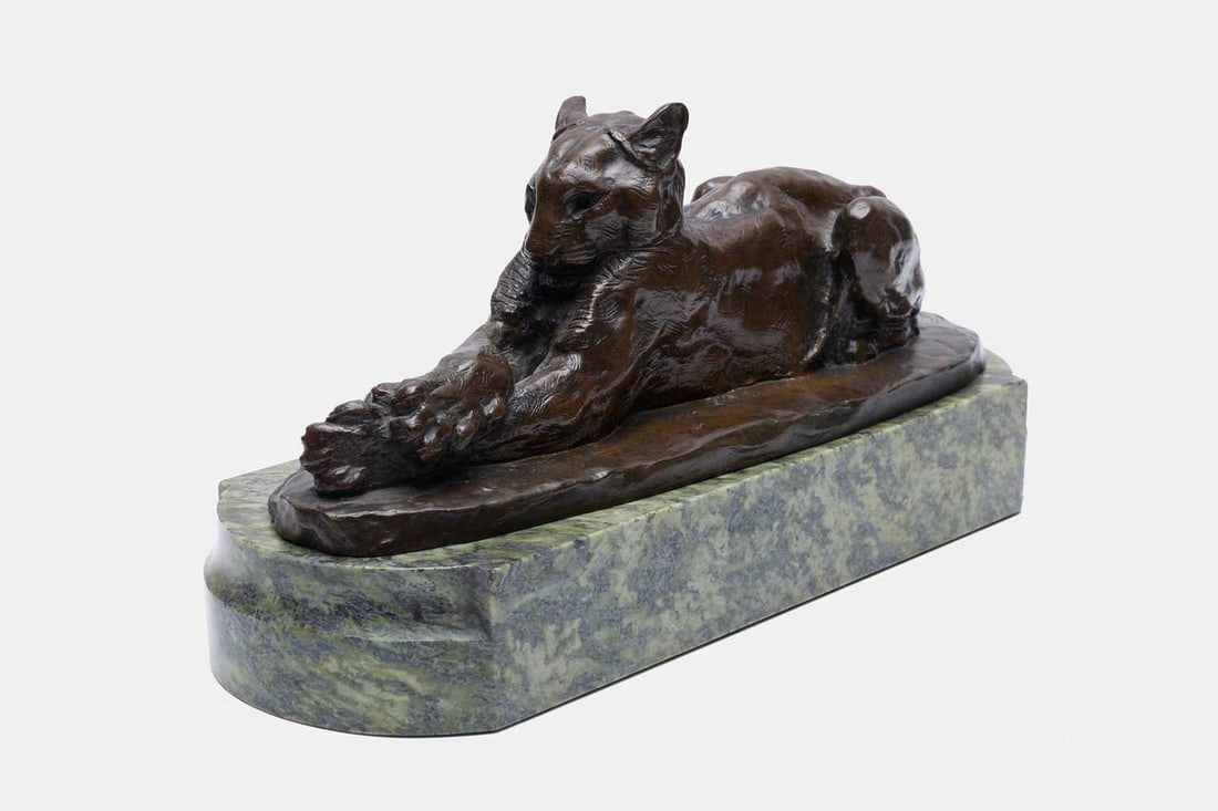 John Macallan Swan RA (British, 1846-1910), a bronze sculpture of a reclining cat clutching a ball,: John Macallan Swan RA (British, 1846-1910), a bronze sculpture of a reclining cat clutching a ball, inscribed 'J M SWAN', raised on a green hardstone plinth base (33cm wide, 12cm deep, 12cm high, 17cm