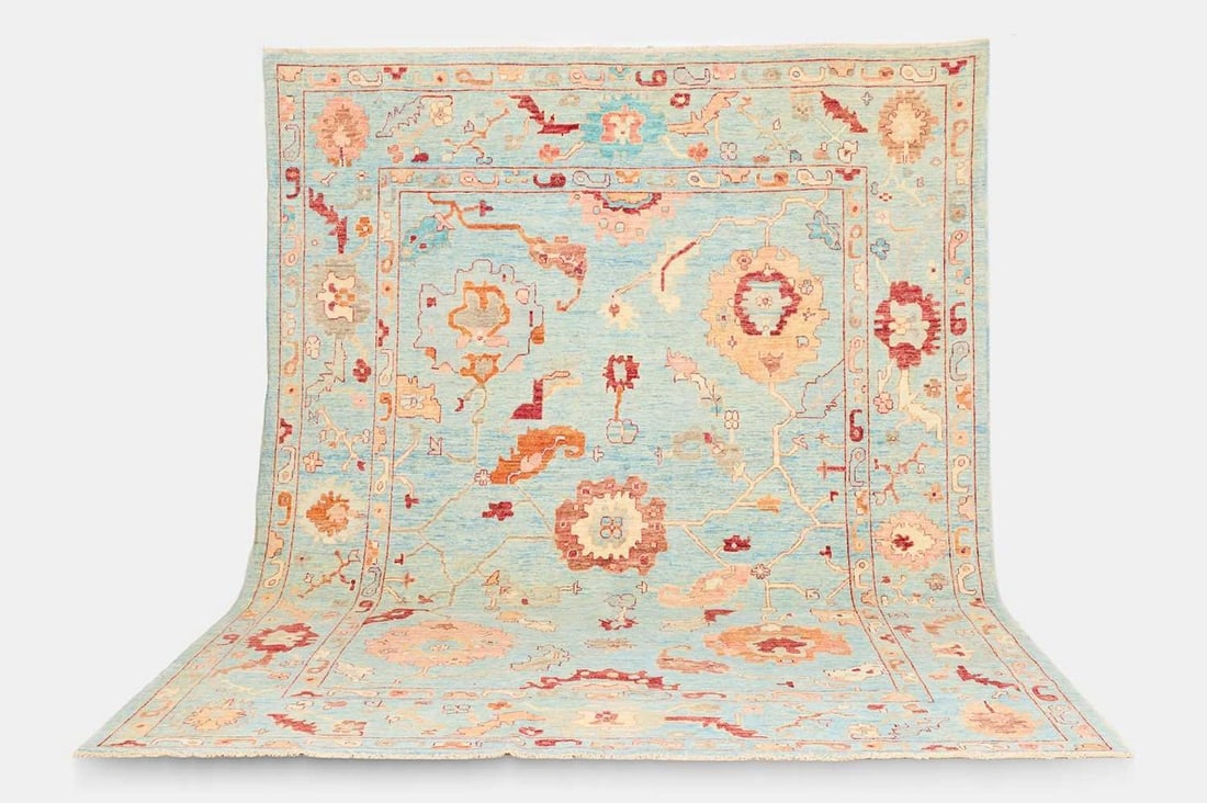 An Oushak wool carpet, of recent manufacture,: An Oushak wool carpet, of recent manufacture, woven with bold Shah Abbasi motifs to a powder-blue ground (370 x 284cm) Condition Report: Overall the piece presents in very good structural and cosmetic