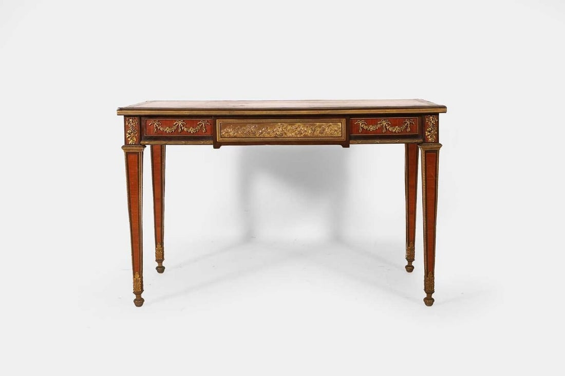 A Napoleon III amaranth, tulipwood and kingwood bureau plat, late 19th century, French,: A Napoleon III amaranth, tulipwood and kingwood bureau plat, late 19th century, French, the rectangular top inset with a gilt-tooled leather skiver, above a single brass-mounted frieze drawer decorate