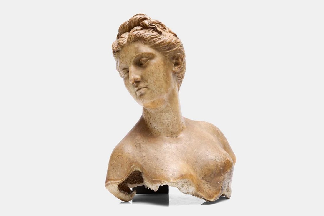 A wax bust of Diana, second half of the 19th century, after the antique,: A wax bust of Diana, second half of the 19th century, after the antique, mounted on an ebonised socle stand (43cm wide, 33cm deep, 56cm high, 72cm high including stand) Condition Report: With general 