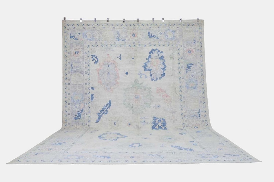 An Oushak wool carpet, of recent manufacture, Anatolian,: An Oushak wool carpet, of recent manufacture, Anatolian, woven with bold foliate and geometric motifs to a pale field (477 x 310cm ) Condition Report: Overall the piece presents in very good structura