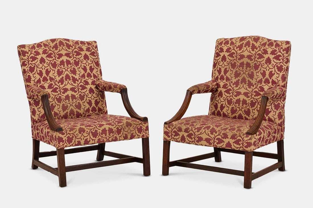 A pair of George III mahogany Gainsborough library armchairs, circa 1780,: A pair of George III mahogany Gainsborough library armchairs, circa 1780, each covered in damask upholstery, the arched top rail over a square back and wide seat, flanked by part-padded downswept reed